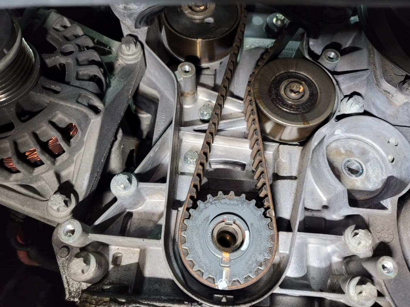 New timing belt installed with its pulleys on an engine